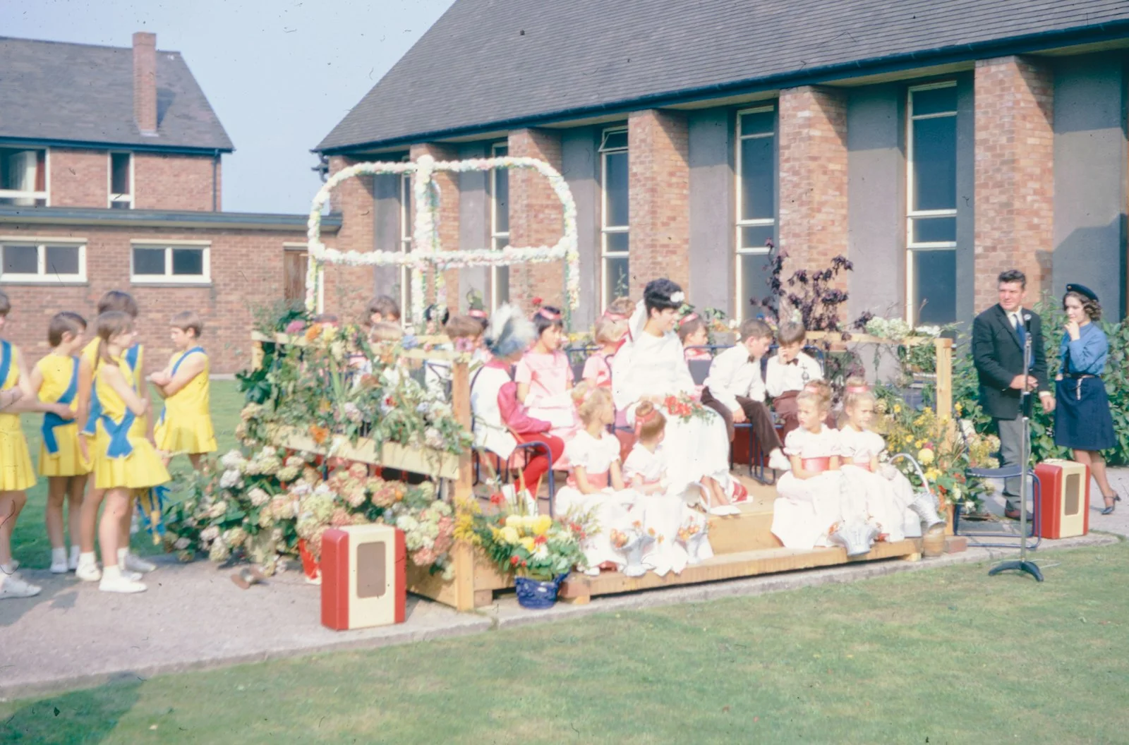 Children are seated on a decorated float